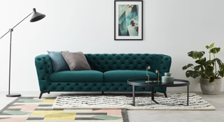 Made sofa in bright emerald with button detailing on the back