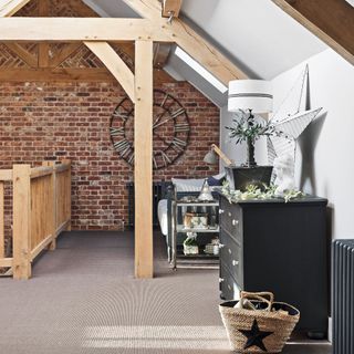 wooden beam on landing with exposed brick