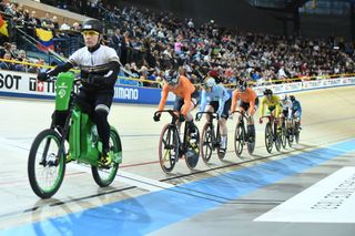 A man rides a derny ahead of cyclists in the women's keirin final during the UCI Track Cycling World Championships