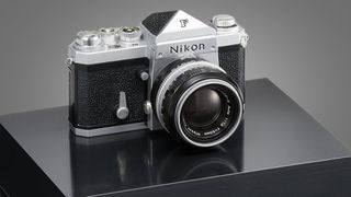 A miniature Nikon F camera on a plinth