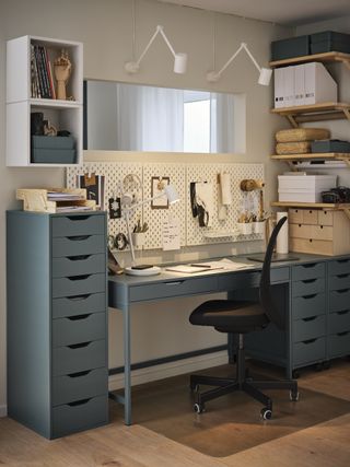 home office with storage units, peg boards, wall lights, shelving, mirror, chair