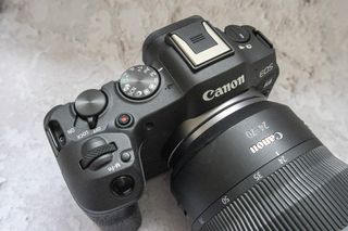 Canon EOS R8 camera on table and closeup of top plate with plain background