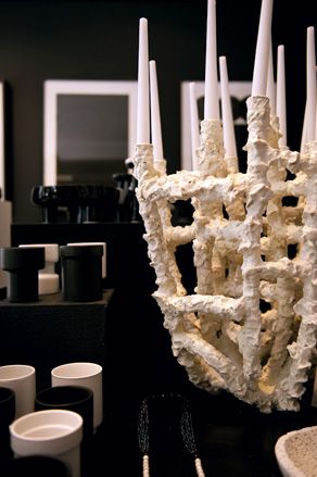 Upclose image of a cream coloured ceramic candle holder, in a room with monochrome interior designs