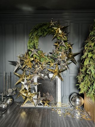 a fireplace decorated wth a christmas wreath and star garland