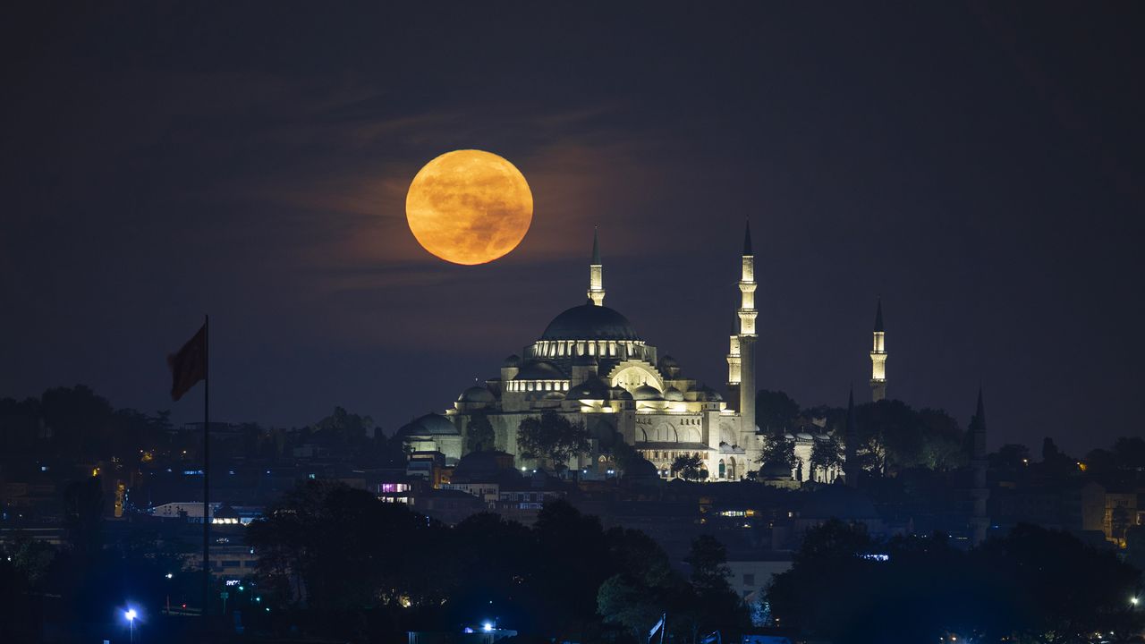Full moon rises over Suleymaniye Mosque in Istanbul, Turkye on October 09, 2022