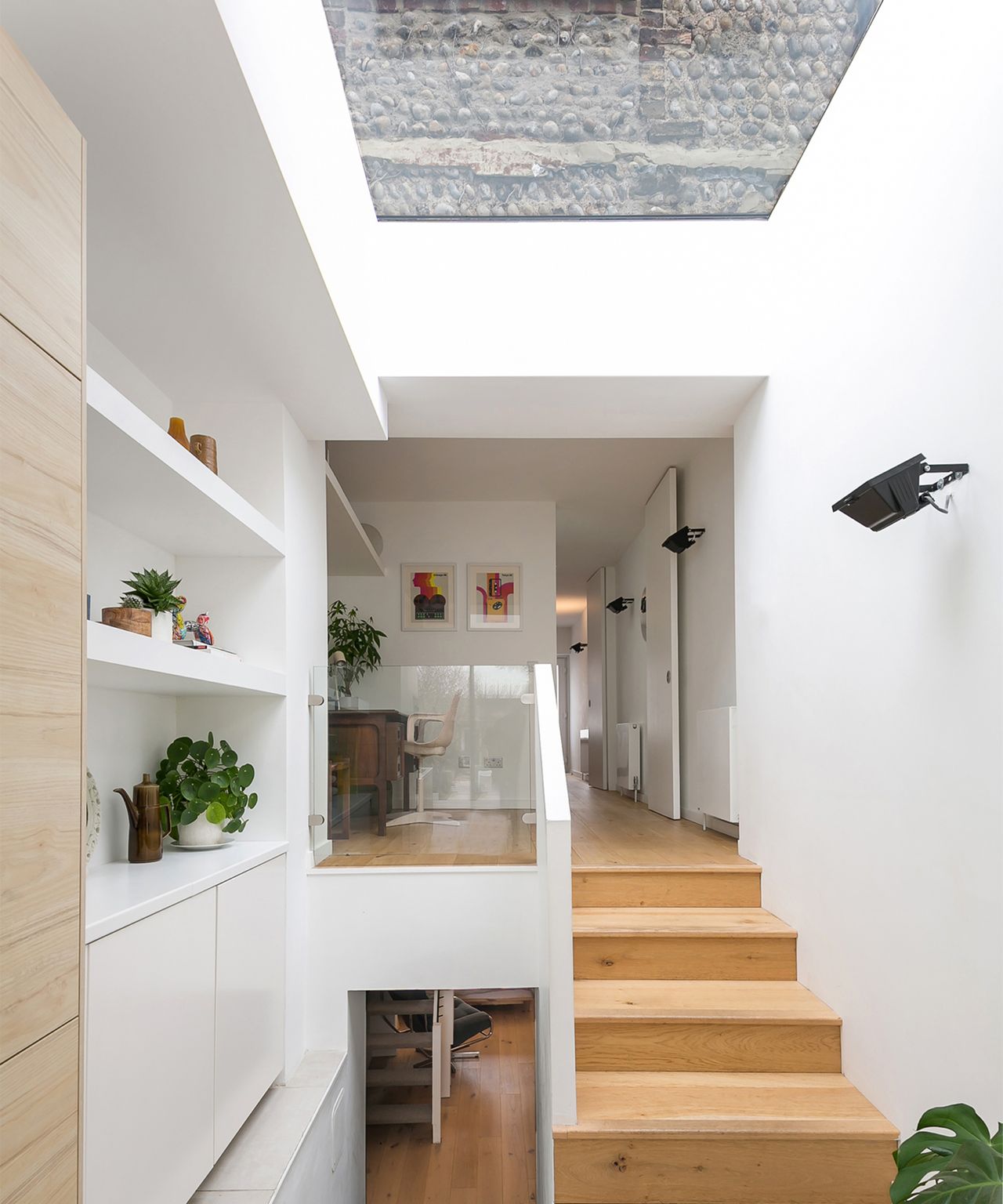 internal view of extension showing staircase connecting floors and large rooflight