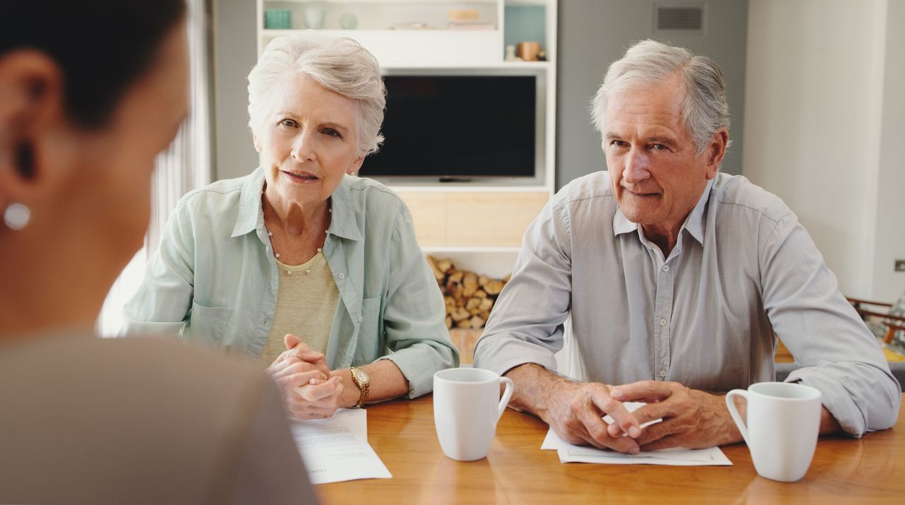 Elderly couple meeting with lawyer or financial advisor for will writing, estate planning, retirement savings and investment planning