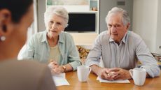 Elderly couple meeting with lawyer or financial advisor for will writing, estate planning, retirement savings and investment planning