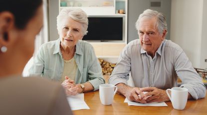 Elderly couple meeting with lawyer or financial advisor for will writing, estate planning, retirement savings and investment planning