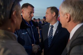 NASA Administrator Jim Bridenstine greets astronaut Nick Hague after his emergency landing during a crew launch to the space station.