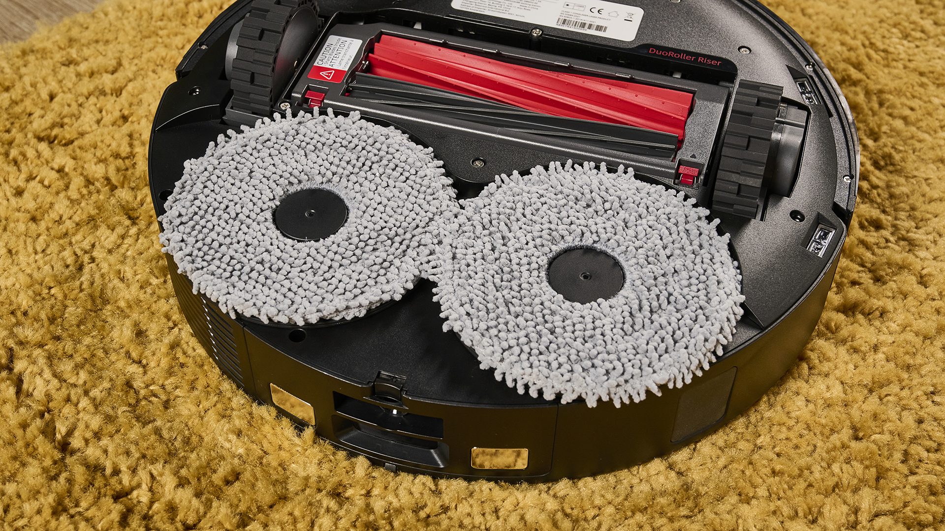 Underside of Roborock Qrevo Master robot vacuum, showing rotating mop pads