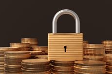 Padlock on a heap of gold coins in black background