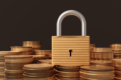 Padlock on a heap of gold coins in black background