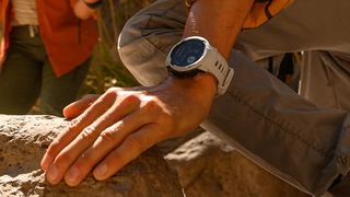 Person rock climbing wearing Garmin Instinct 2 Solar watch