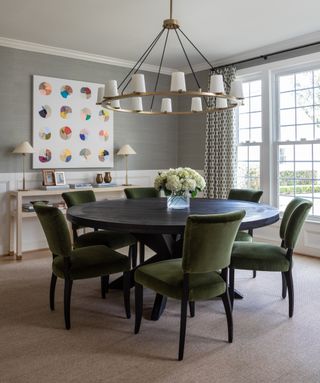 Green velvet dining chairs, grey wallpaper, black table