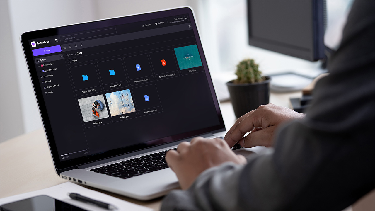 Person using Proton Drive on a laptop