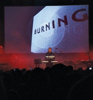 Using analogue keyboards, John Foxx and his band perform with Jonathan Barnbrook mixing video graphics projected onto the backdrop
