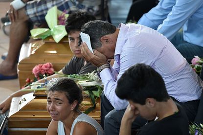 Mourners at the funeral for 35 victims of the earthquake in Italy