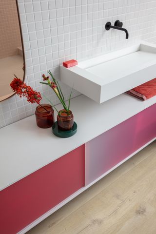 white bathroom with pink cabinets and a matt black basin tap