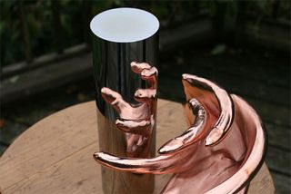 When placed in front of a cylindrical mirror the reflection reveals the original object