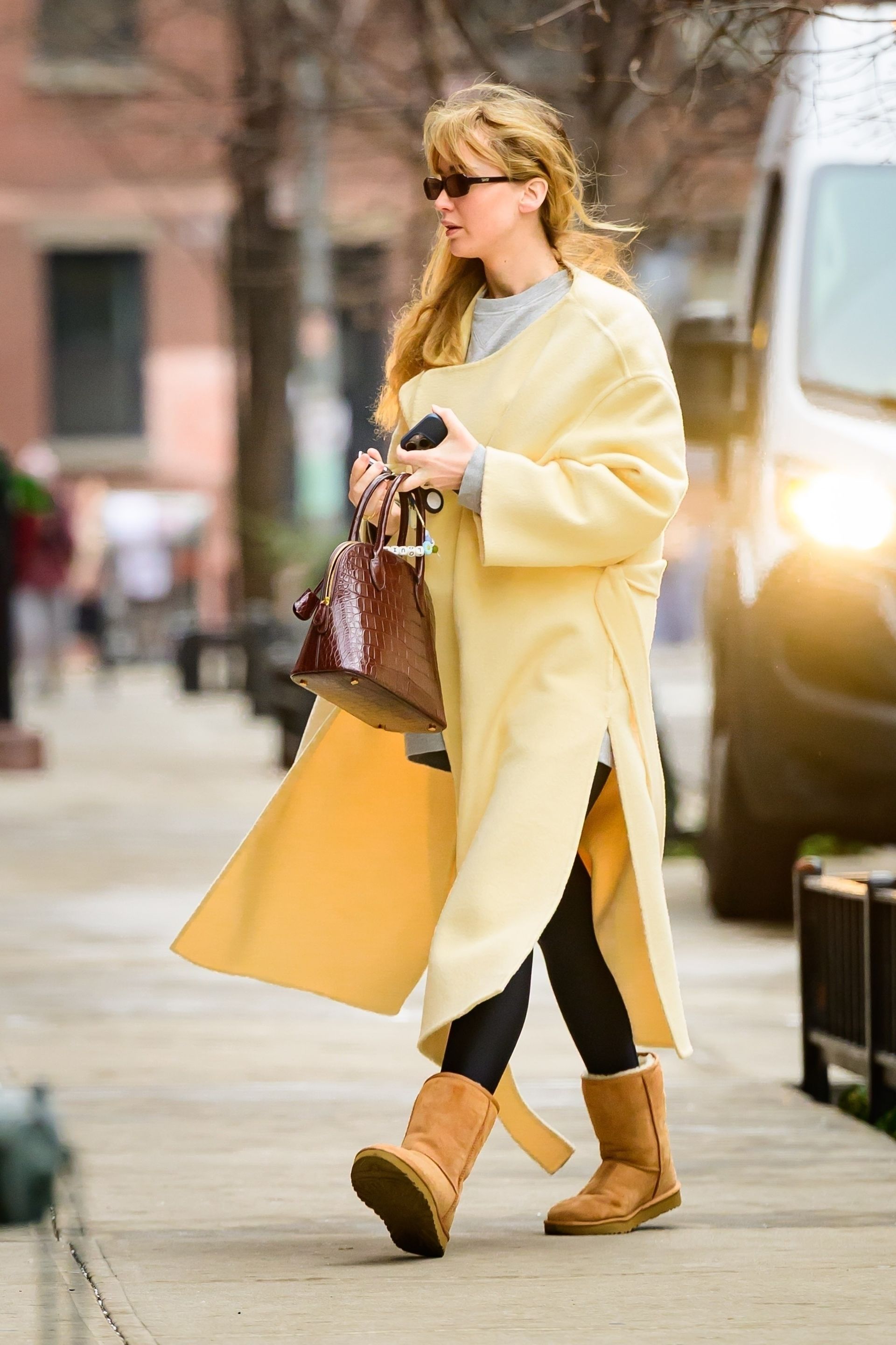 Jennifer Lawrence in yellow coat and ugg boots