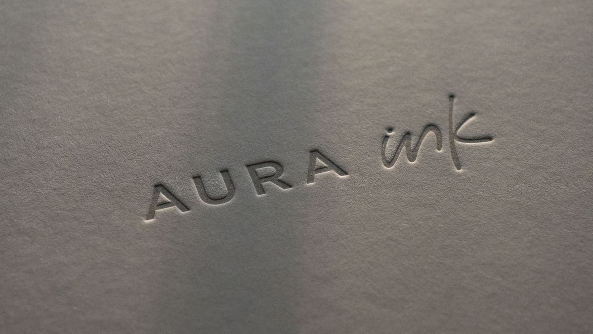 The close up of the Aura Ink 'E Ink' digital photo frame's presentation box, illuminated by the golden hour sun