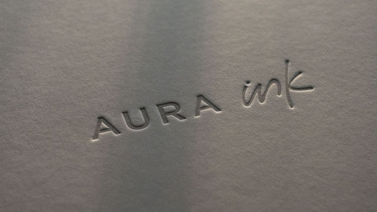 The close up of the Aura Ink 'E Ink' digital photo frame's presentation box, illuminated by the golden hour sun