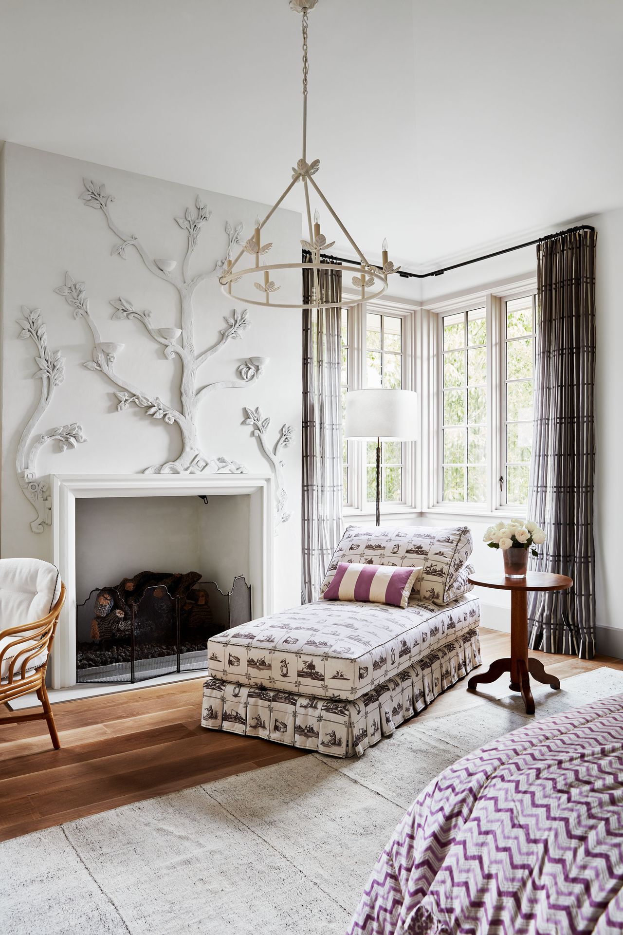 Tree design fireplace , dark wood floors and white rug
