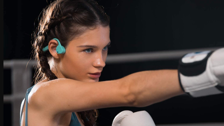 Woman boxing wearing Vidonn F3 bone conduction headphones