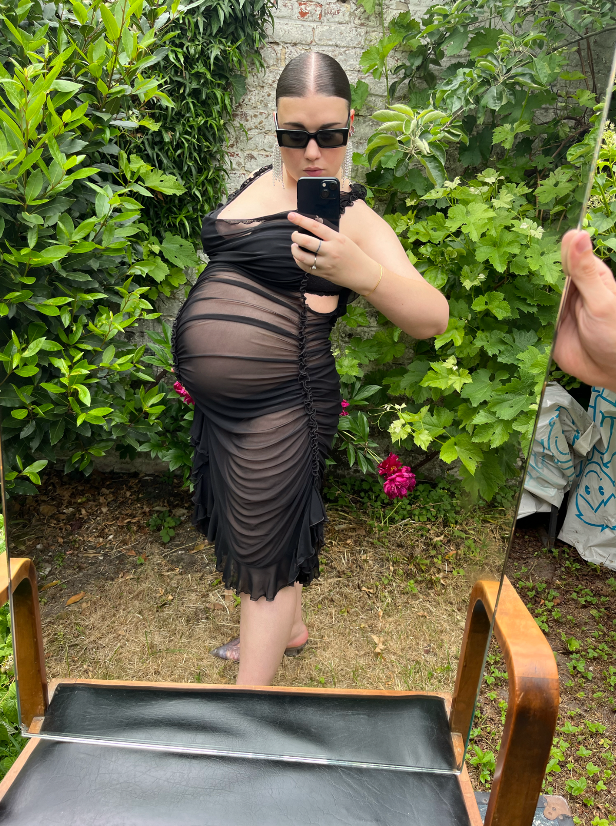 ester manas wears a sheer black dress