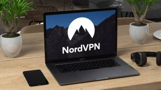 NordVPN logo on a laptop sitting on a desk