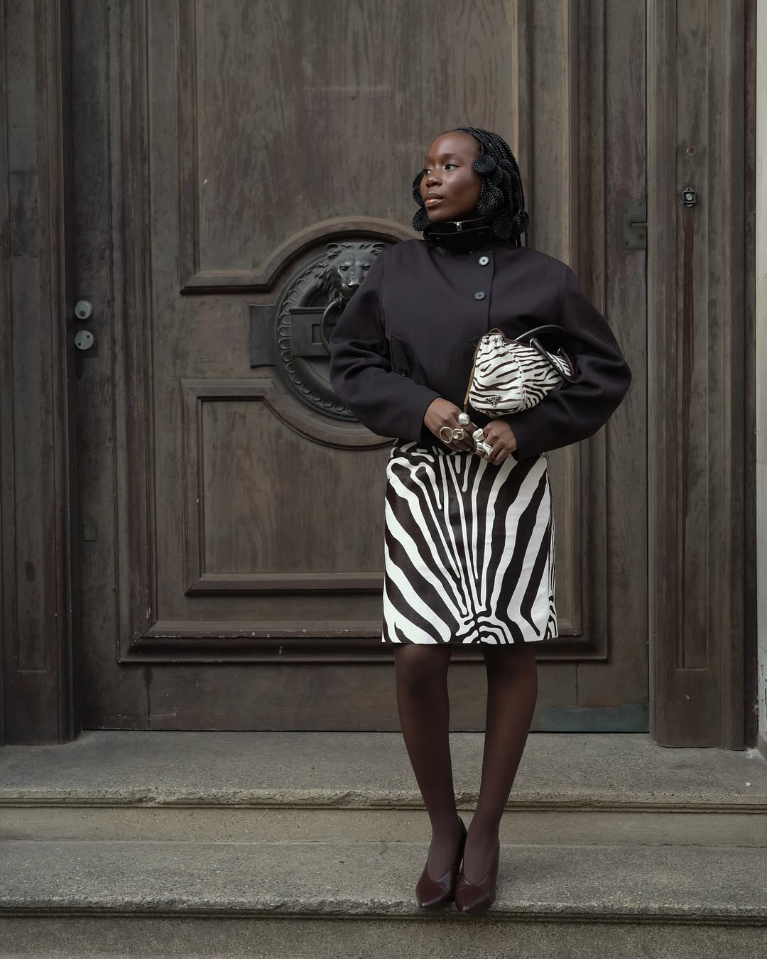 Danielle Oreoluwa Jinadu wears zebra print skirt black top