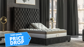 Saatva Solaire adjustable mattress with one side of the bed raised slightly, and a blue price drop label over the top of the image