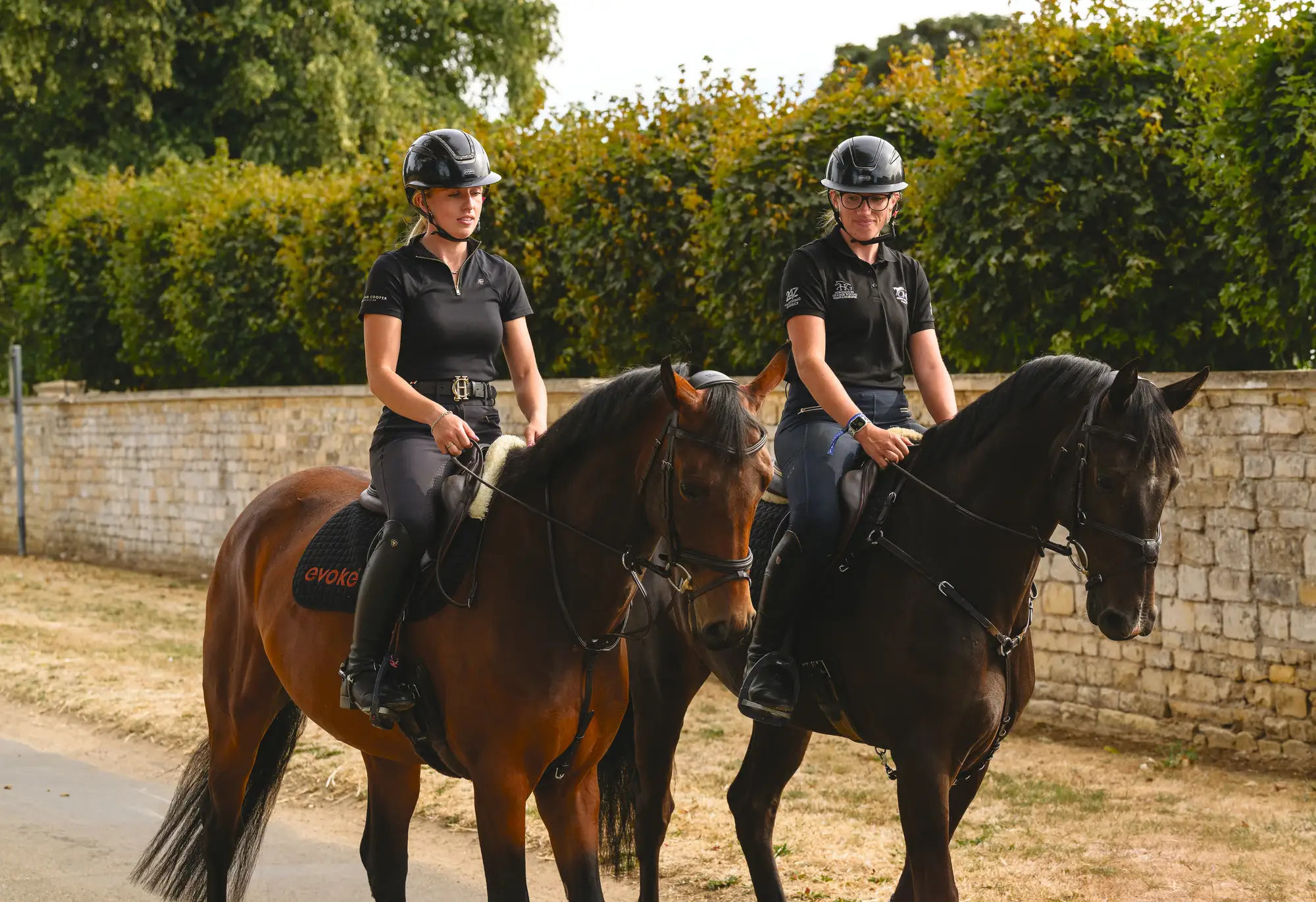 Cerys Macaulay and her groom hack out two horses on a country road