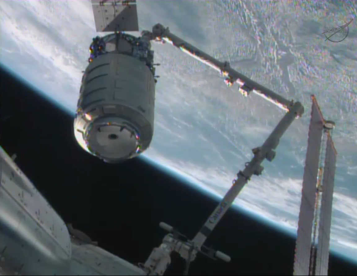 The first commercial Cygnus spacecraft is moved into docking position by the International Space Station&#039;s robotic arm on Sept. 29, 2013 after arriving at the orbiting lab during a major test flight by spacecraft builder Orbital Sciences Corp.