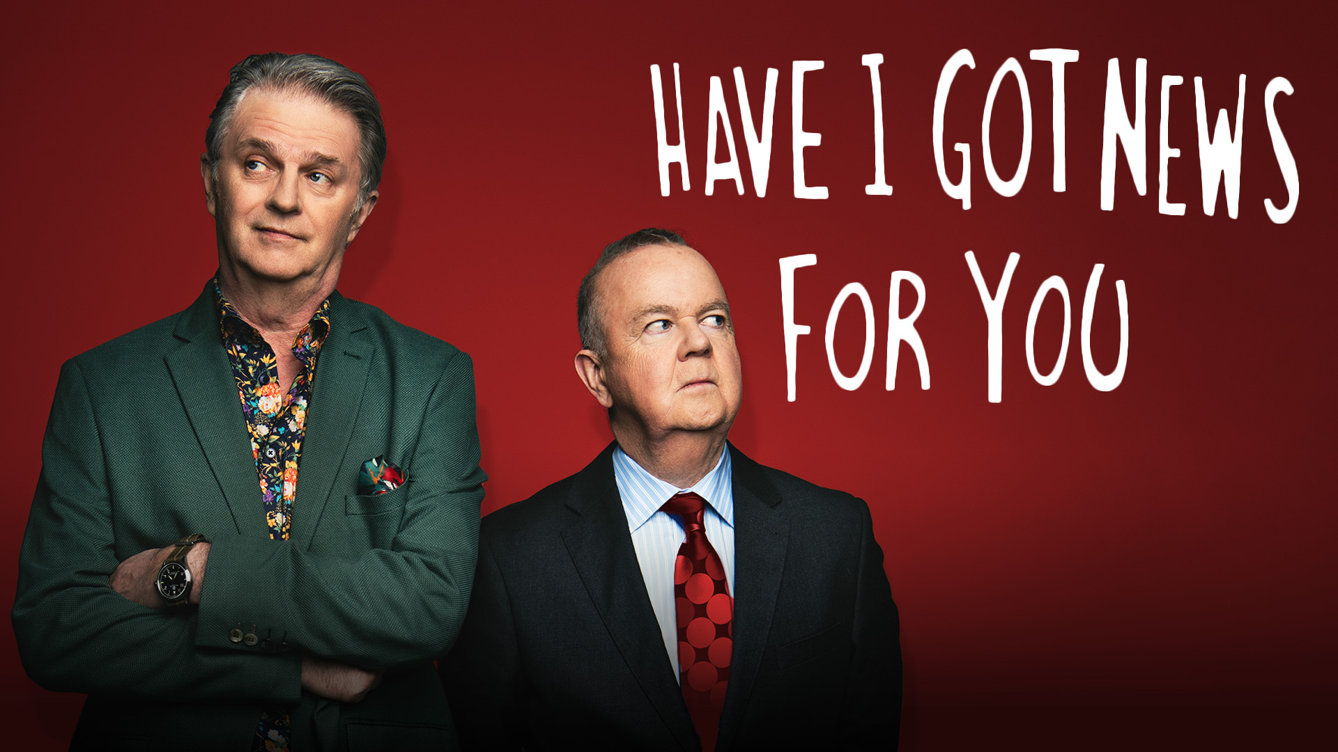 Paul Merton and Ian Hislop looking in different directions set against a dark red background with Have I Got News for You written in white in the top right hand corner.