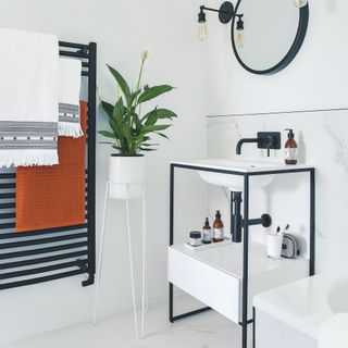 white bathroom with black frame basin stand