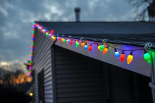 Christmas lights hanging from a roof
