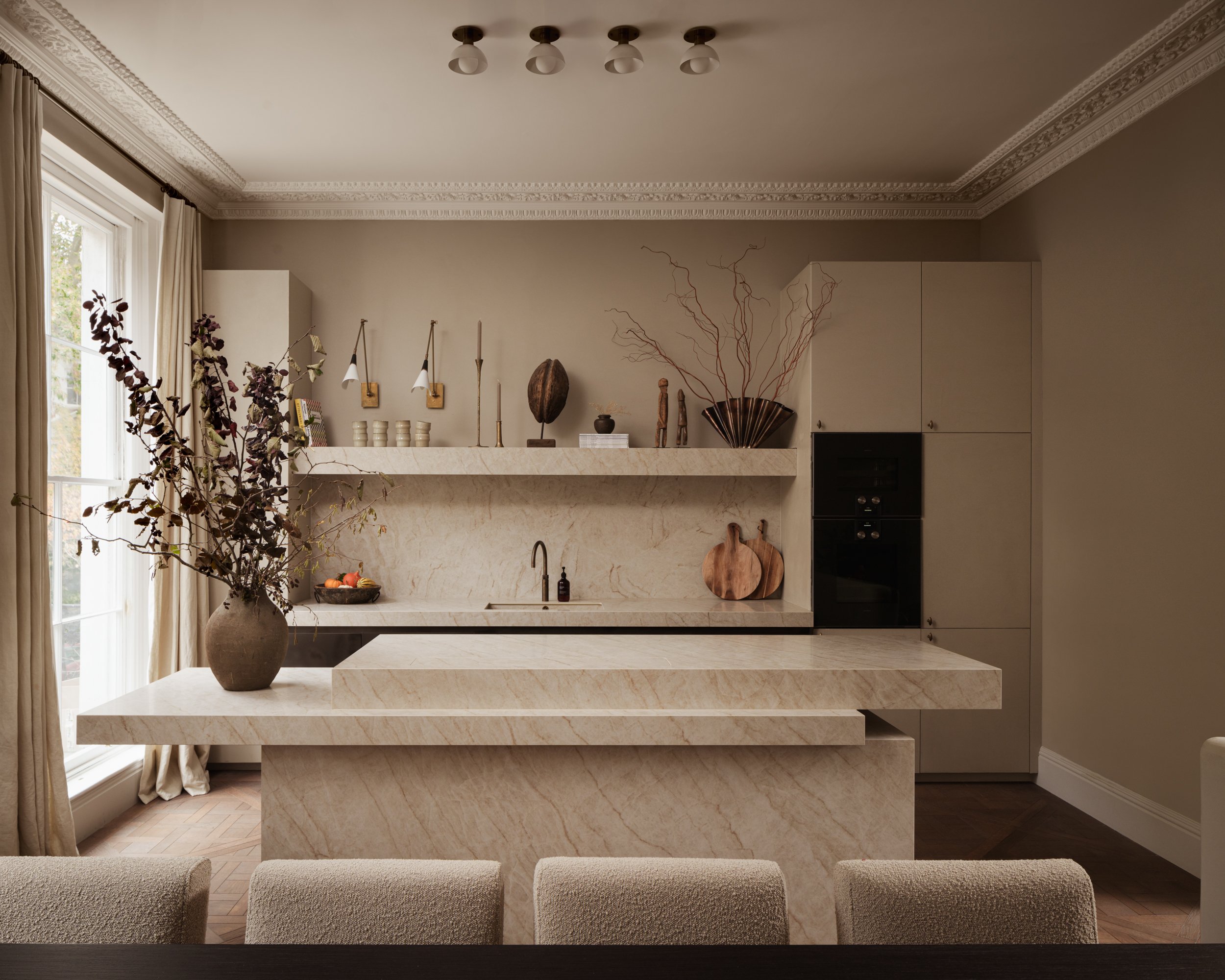 A kitchen with floor-to-ceiling linen curtains
