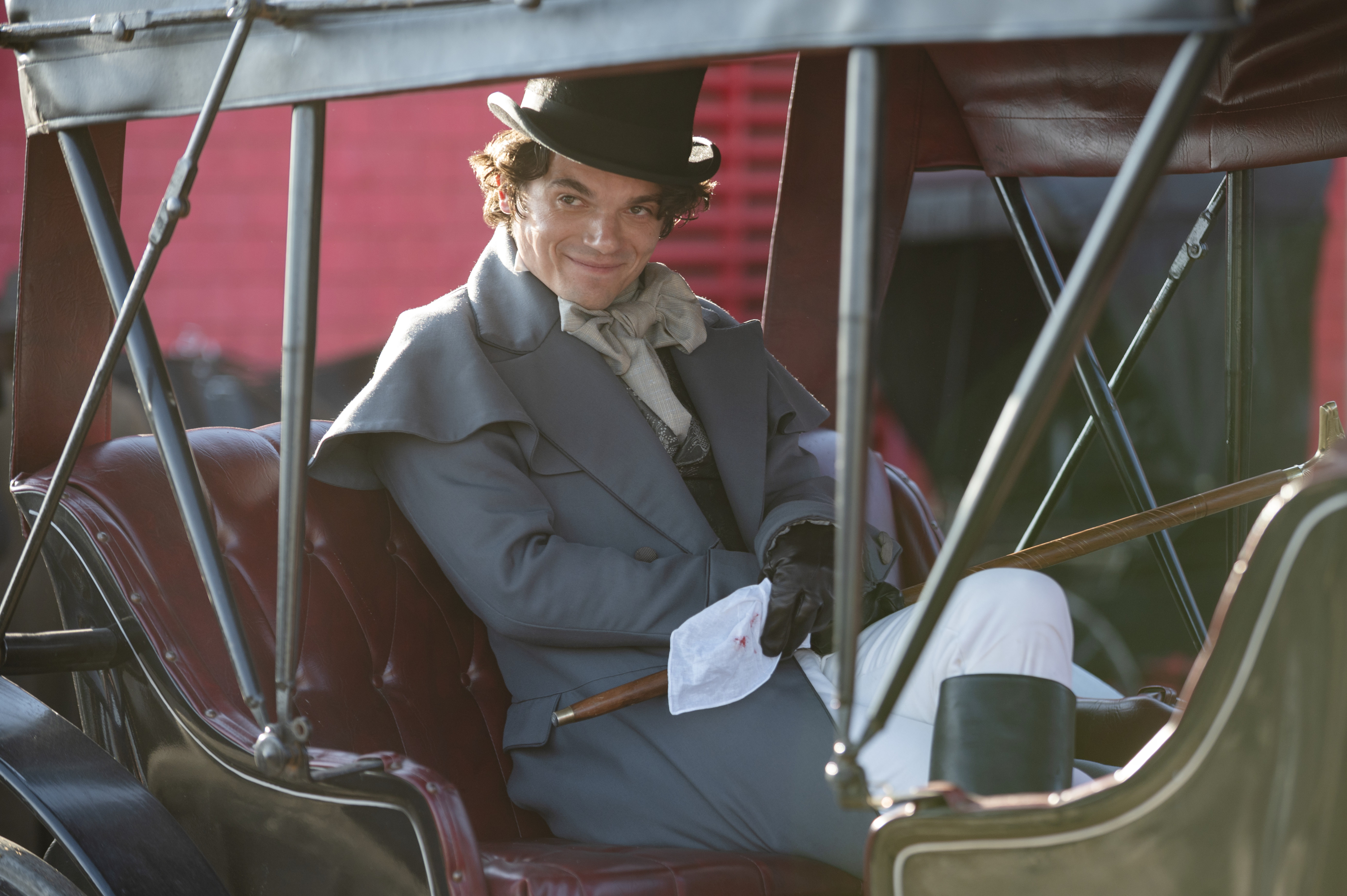 Edward Bluemel as Billy McGee, sitting in an 1800s carriage, in 'Washington Black.'