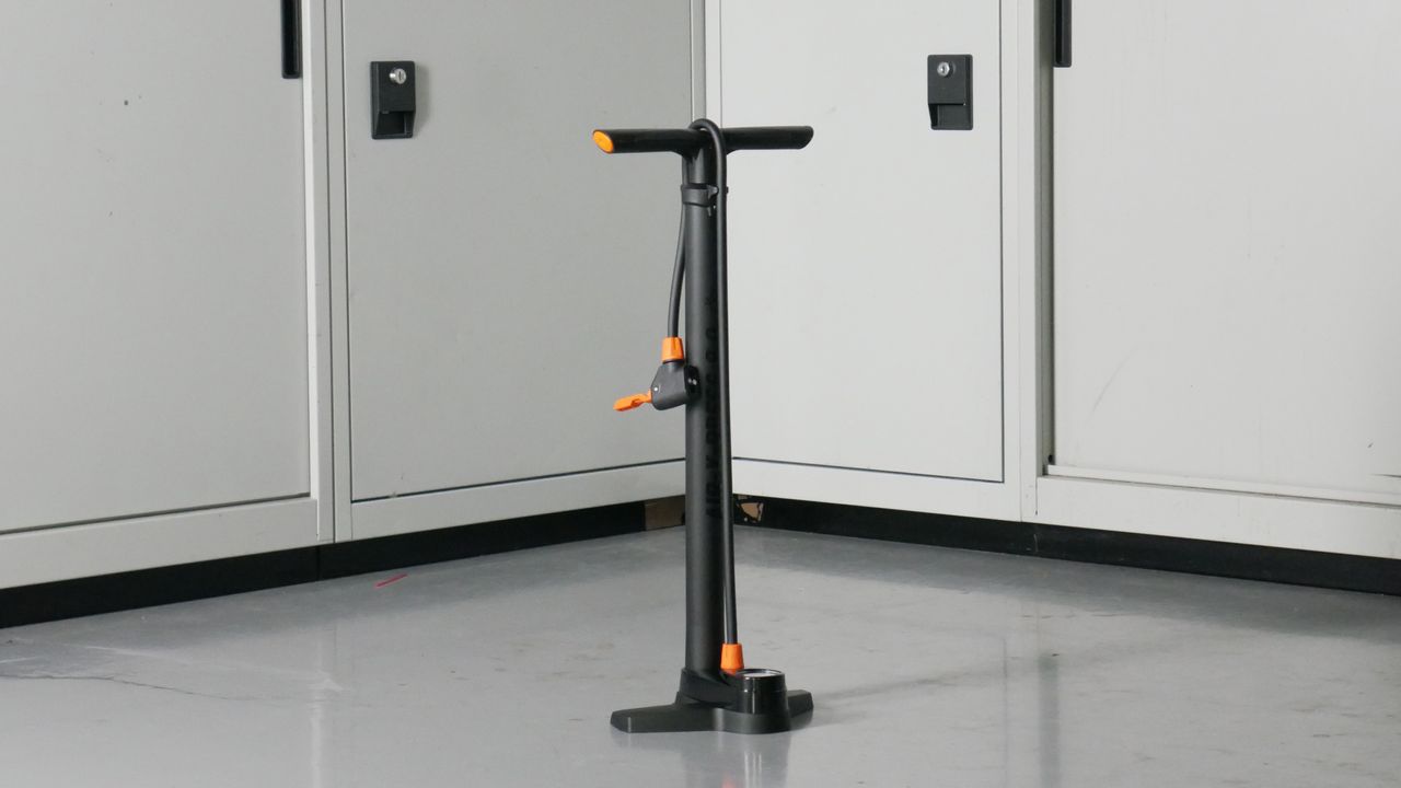 SKS Air-X-Press bike track pump in black and Orange set to a background of some workshop cabinets