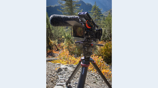 Sachtler tripod being used on a trail on a mountain