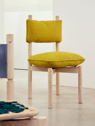 A ‘Paf Paf’ chair, designed by Studio Irvine for Mattiazzi, features an ash frame and cushions padded with recycled feathers and upholstered in Kvadrat fabric