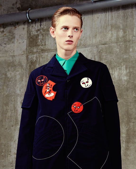 Model wearing blue blazer with red motifs