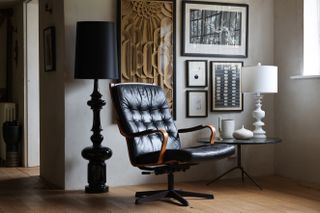 Living room with black chair and floor lamp by Rockett St George