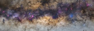 A panoramic view of the Milky Way's core, captured from the Atacama Desert in Chile. Emission nebulas are shown in pink, and the blue spots are reflection nebulas.