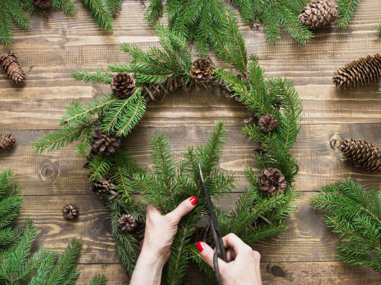 Person Making A DIY Evergreen Wreath