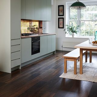 kitchen room with wooden flooring and table with chairs