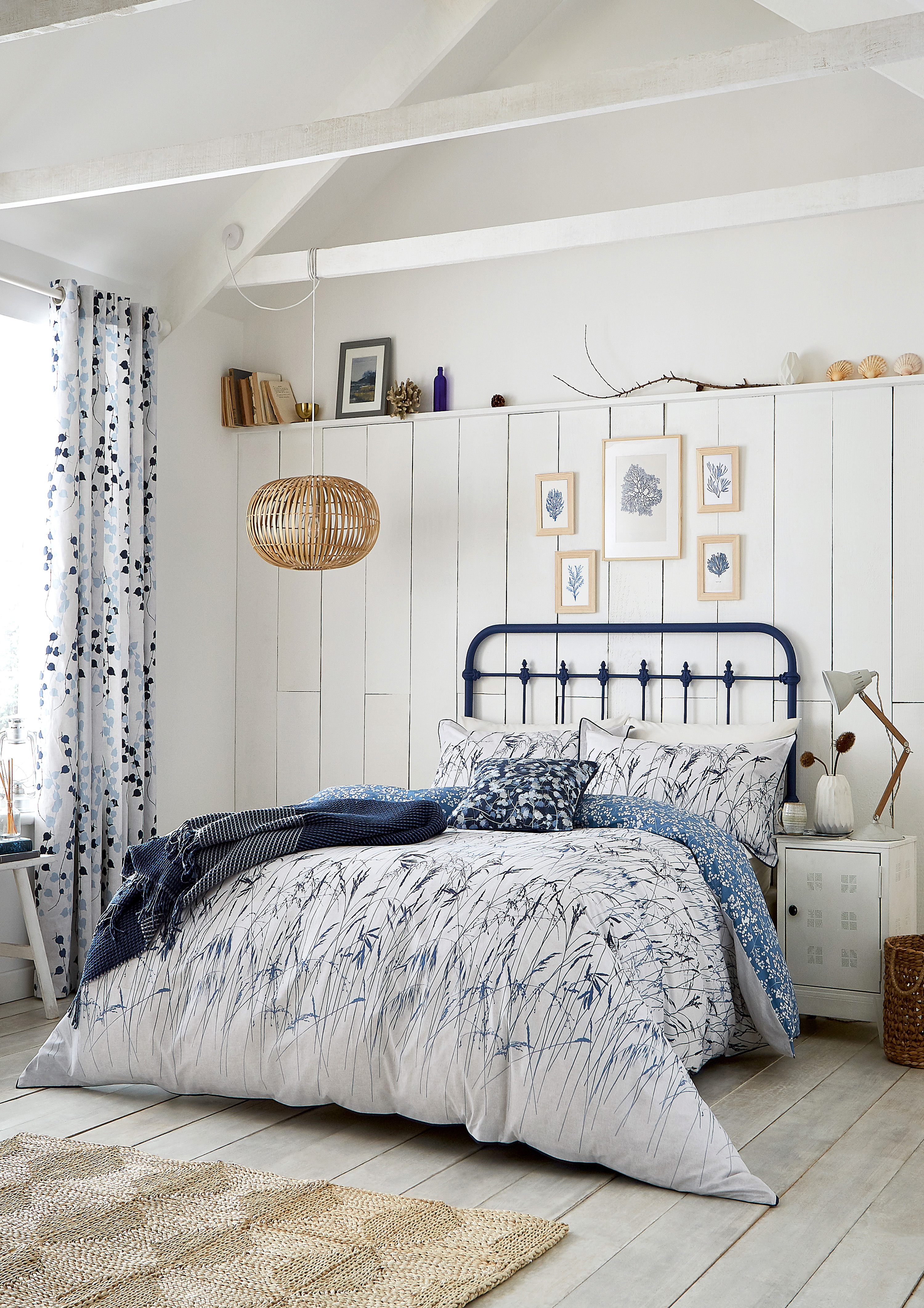 Blue and white bedroom with floral matching bed linen and curtains