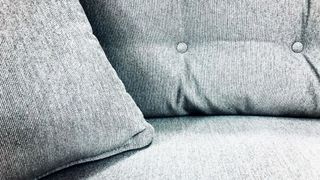 close up of a upholstered grey sofa